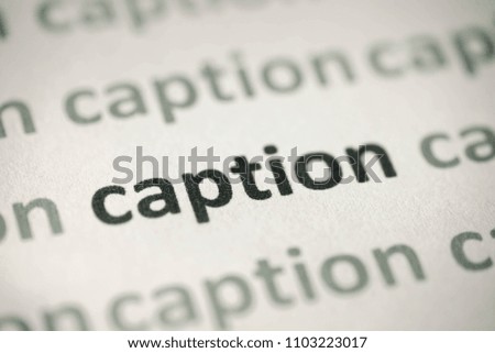 word caption printed on white paper macro