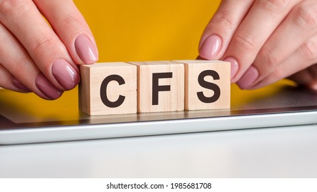 The Word Cfs Written On Wooden Cubes Standing On A Notepad. Selective Focus. Business, Financial Concept. Cfs Short For Consolidated Financial Statement