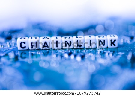 Word CHAINLINK formed by alphabet blocks on mother cryptocurrency