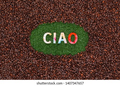 Word Ciao With Colorful Letters On Artificial Grass Surrounded By Roasted Coffee Beans