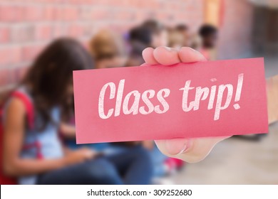 The Word Class Trip! And Hand Showing Card Against Cute Pupils Using Mobile Phone