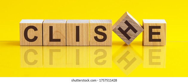 Word CLICHE made with wood building blocks on a bright yellow back ground. The image is mirrored in the glossy surface. For your design, the concept is front view. - Shutterstock ID 1757511428