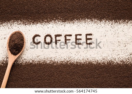 Word coffee created from ground coffee in the kitchen. Enjoying a coffee break. 