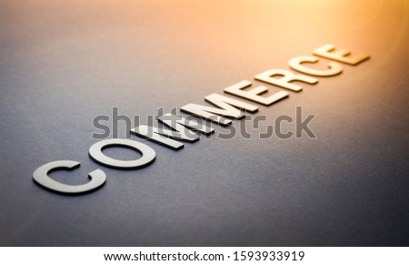 Word commerce written with white solid letters on a board