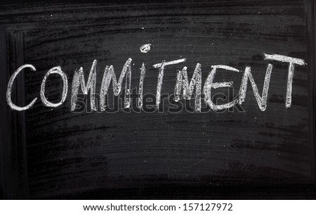 The word Commitment on a blackboard. We look for commitment in our relationships but also in our jobs and the pursuit of an education.