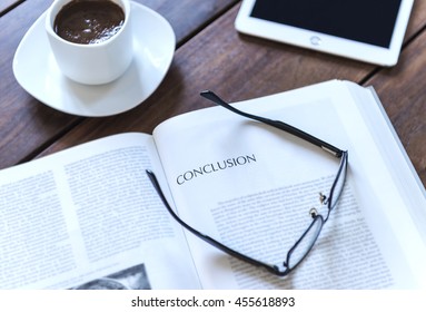 Word conclusion on a white book page rounded by black glasses - Shutterstock ID 455618893
