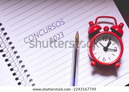 
The word Concursos ( civil service exam ) in Brazilian Portuguese with the year 2023 on a notebook sheet. Imagine de stoc © 