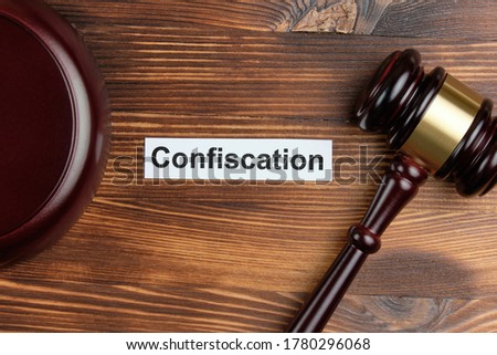 The word confiscation on a white sticker next to the judge hammer.