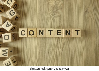 Word content from wooden blocks on desk - Shutterstock ID 1698354928