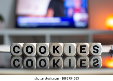 The Word Cookies Written With Wooden Dices Reflecting On A Black Computer Screen 