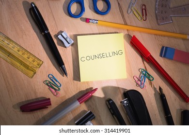 The word counselling against students table with school supplies