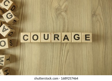 Word courage from wooden blocks on desk - Shutterstock ID 1689257464