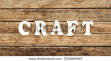 The word Craft written on wood letters on wooden background, top view.