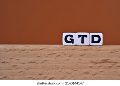 Word cubes lined up with the letters GTD written on it. It is an abbreviation for Getting Things Done. Copy space available.