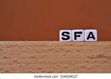 Word cubes lined up with the letters SFA written on it. It is an abbreviation for Sales Force Automation. Copy space available.