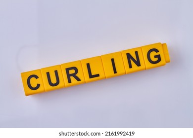 The word curling written on yellow cubes isolated on white background. Type of winter sports game.