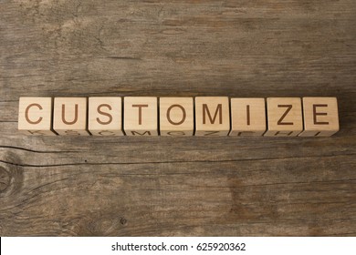 word customize on cubes on wooden background