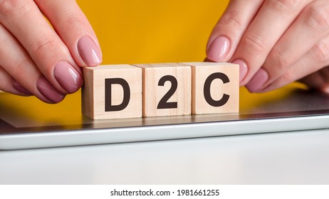 The Word D2c Written On Wooden Cubes Standing On A Notepad. Selective Focus. Business, Education, Financial Concept. D2c - Short For Direct To Consumer