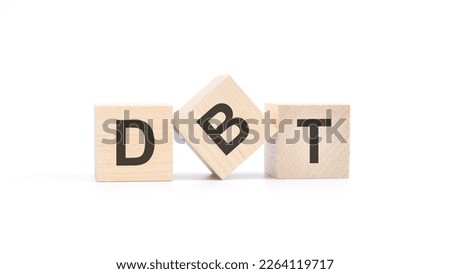 word DBT made with wood building blocks, white background.