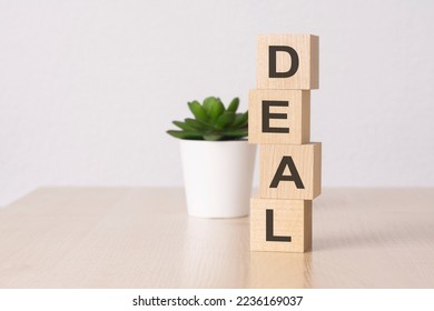 word DEAL with wood building blocks, light green background. front view. - Shutterstock ID 2236169037
