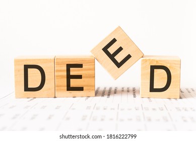 Word deed. Wooden small cubes with letters isolated on white background with copy space available - Shutterstock ID 1816222799