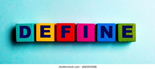 The word DEFINE is written on multicolored bright wooden cubes on a light blue background