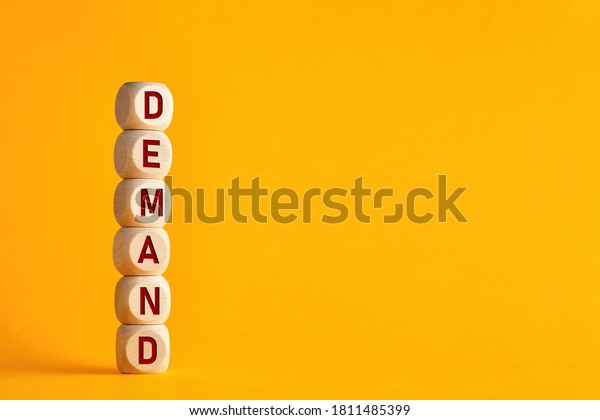 The word demand on stacked\
wooden cubes. Demand increase or rise in economy or business\
concept.