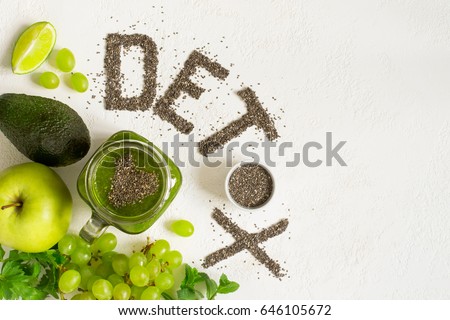 Word detox is made from chia seeds. Green smoothies and ingredients. Concept of diet, cleansing the body, healthy eating. Top view with copy space.
