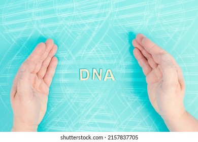 The word DNA is standing between the hands, genetic therapy and treatment, biotechnology in mordern medicine, health care 