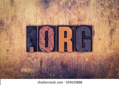 The word "Dot Org" written in dirty vintage letterpress type on a aged wooden background.