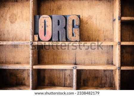 The word DOT ORG written in vintage wooden letterpress type in a wooden type drawer.
