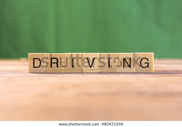 the word of DRIVING\
on wood tiles concept
