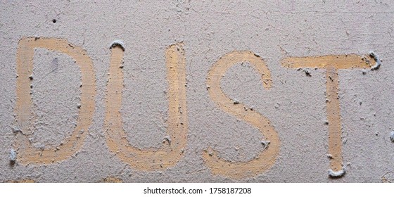 The Word Dust Is Written On A Dusty Table.