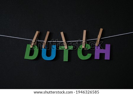 Word Dutch on black background. In Dutch, the names for the Netherlands, the Dutch language and a Dutch citizen are Nederland, Nederlands and Nederlander.
