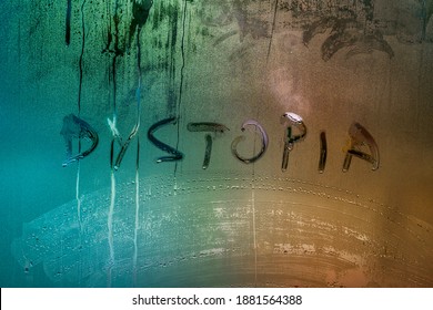 the word dystopia handwritten on wet window glass surface