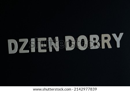 Word 'Dzien Dobry' on black background. Dzien Dobry is the word for Polish say Hello or greetings.