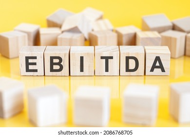 the word ebitda is written on a wooden cubes structure. blocks on a bright background. can be used for business, education, financial concept. selective focus