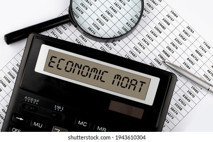 Word ECONOMIC MOAT On The Calculator On Chart . Business And Tax Concept.