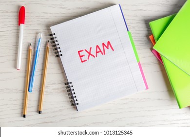 Word EXAM Written In Notebook On Table