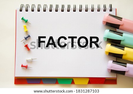  the word factor is written on a notepad. the word factor is used in business, education, medicine. High quality photo