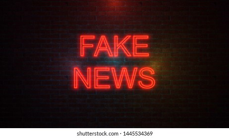 The word FAKE NEWS with neon colours on brick wall. 