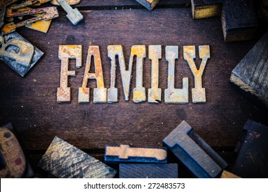 The word FAMILY written in rusted metal letters surrounded by vintage wooden and metal letterpress type.