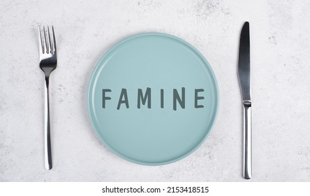 The Word Famine Is Standing On The Empty Plate, Food Shortage And Starving Because Of War And Pandemic, Political Issue