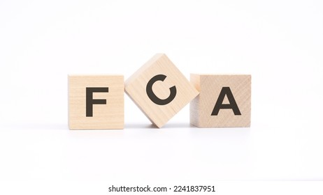 word FCA - Financial Conduct Authority - made with wood building blocks, white background. - Shutterstock ID 2241837951