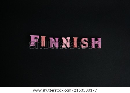 Word Finnish on black background. Finnish is the language of the Finns.