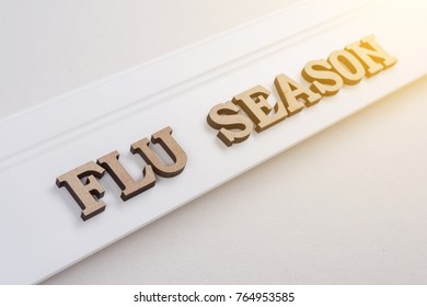 Word FLU SEASON Abstract Wooden Letters, White Background Copy Space