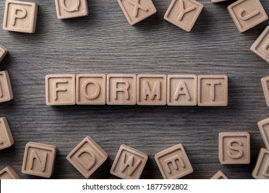 the word "format" is made up of square wooden cubes with letters on a wooden gray surface - Shutterstock ID 1877592802