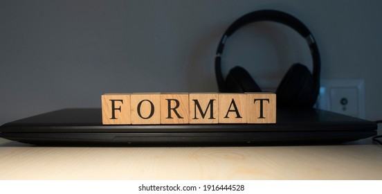 the word format is made up of square wooden cubes with letters . - Shutterstock ID 1916444528