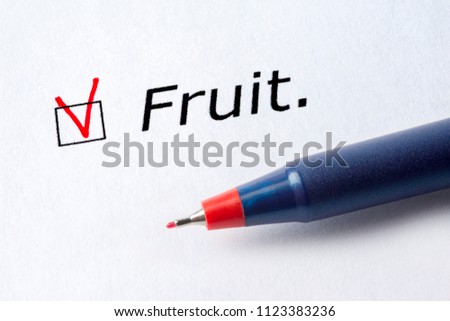 The word fruit is printed on a white background. Check mark in red, marked in the square.