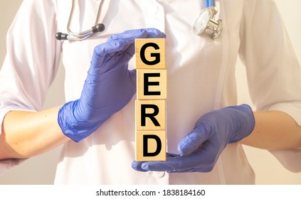 Word Gerd On Wooden Cubes In Doctor Hands Close Up, Medical Concept